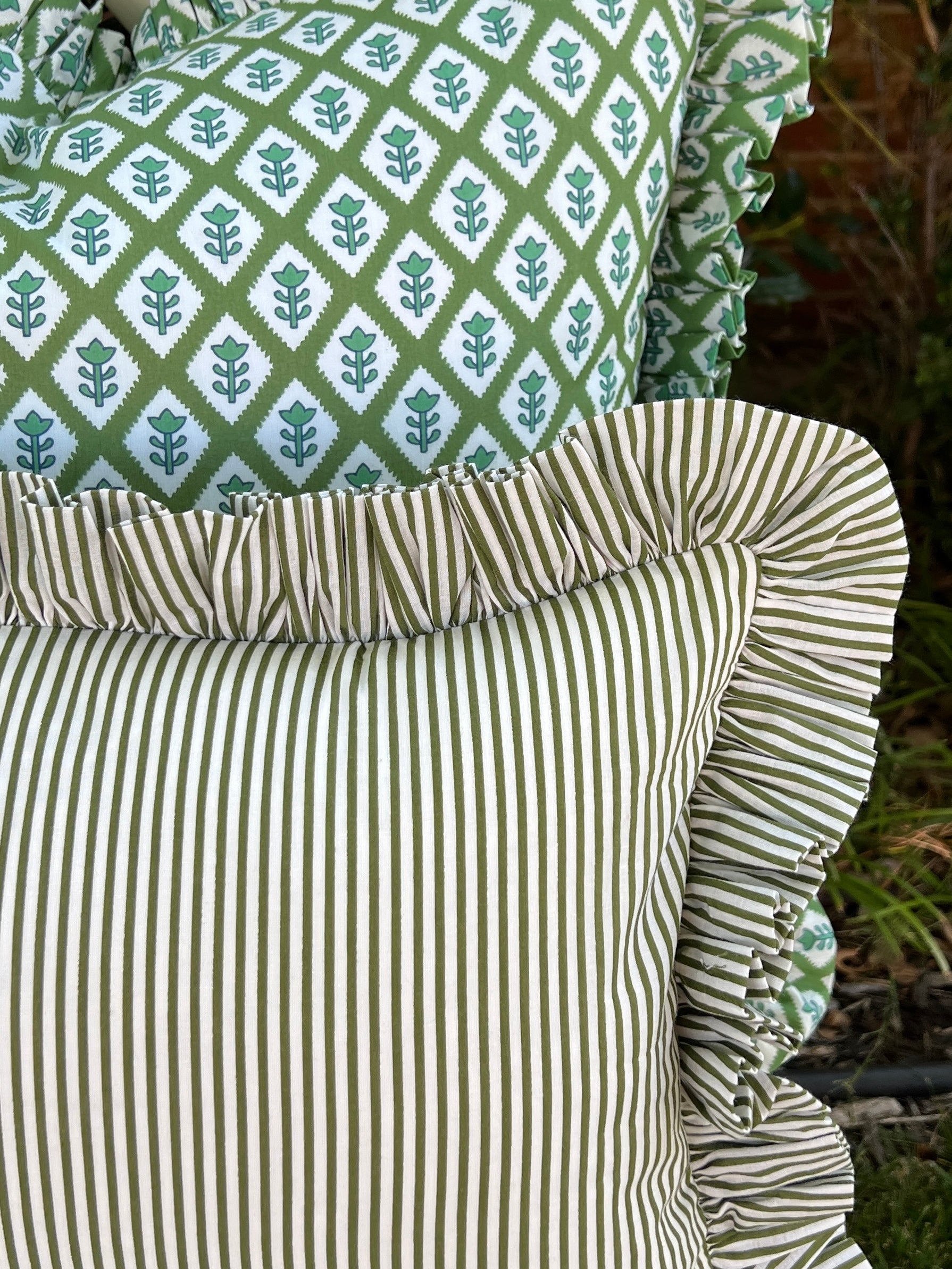 Green and off white striped pillow cover with ruffle trim