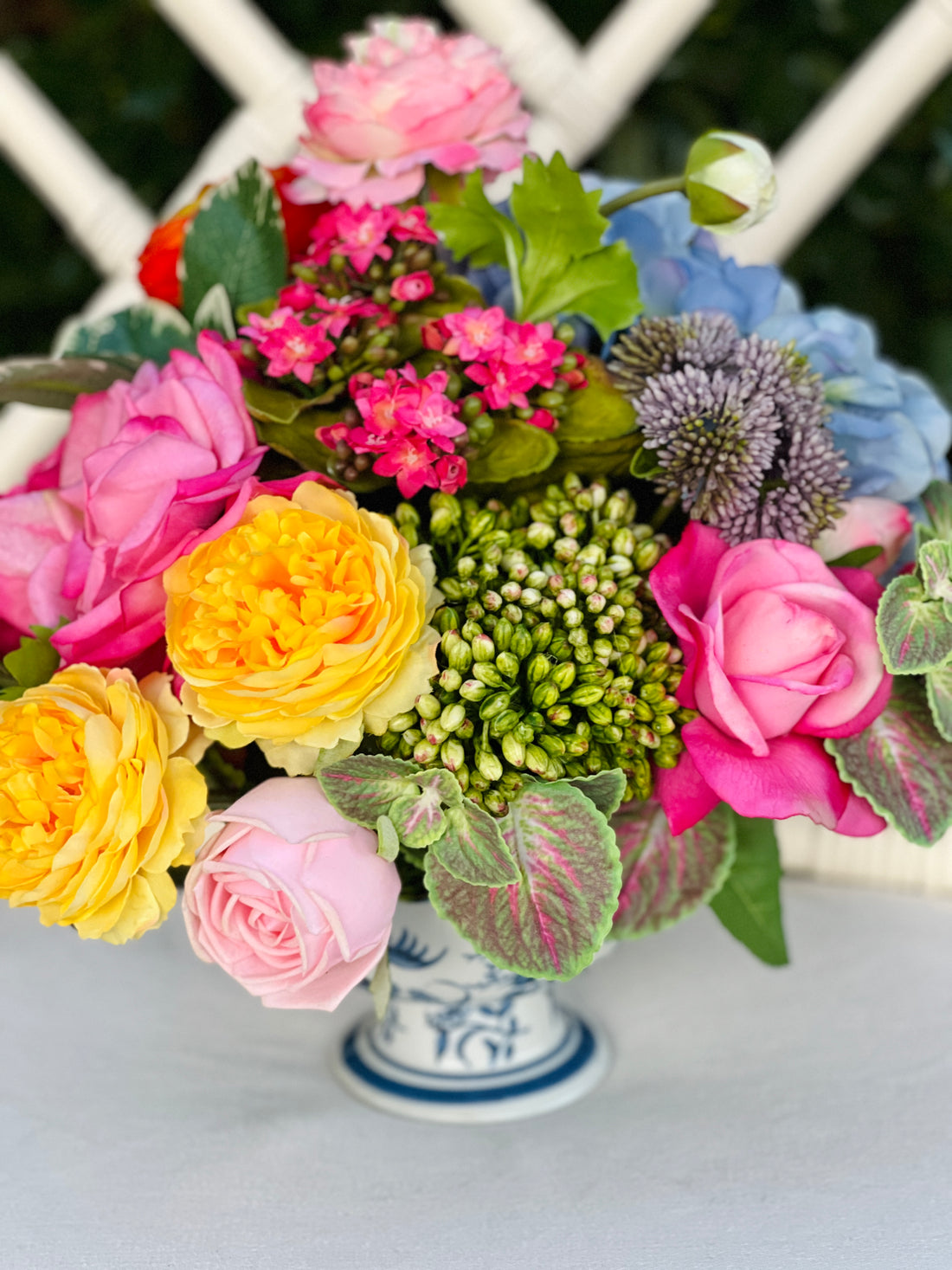 Bright mixed floral arrangement in chinoiserie footed bowl