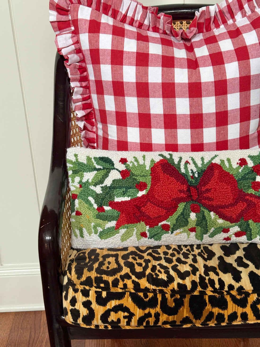 Red bow and greenery hand hooked lumbar pillow