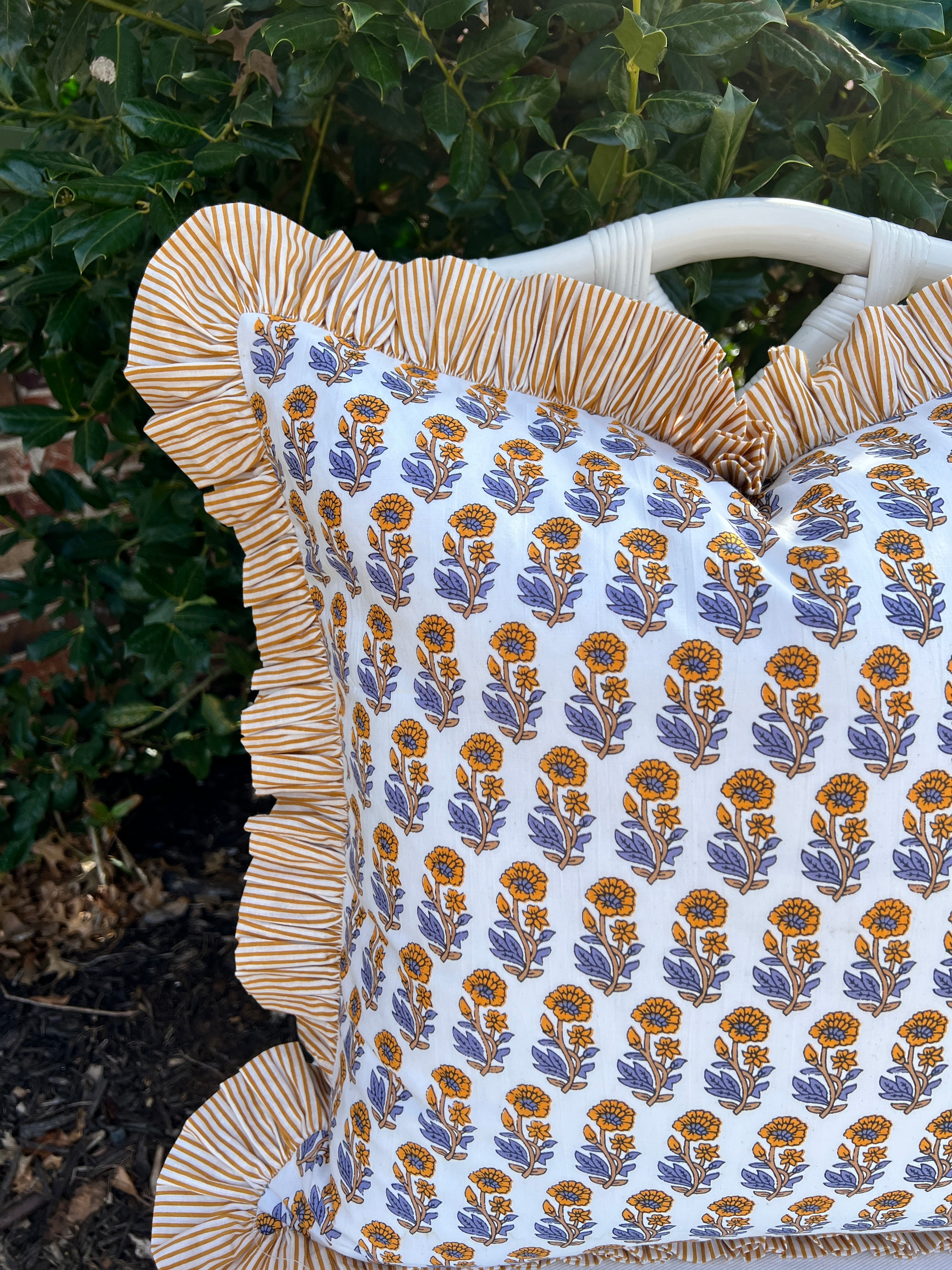 Yellow and blue block print pillow cover with striped contrast ruffle