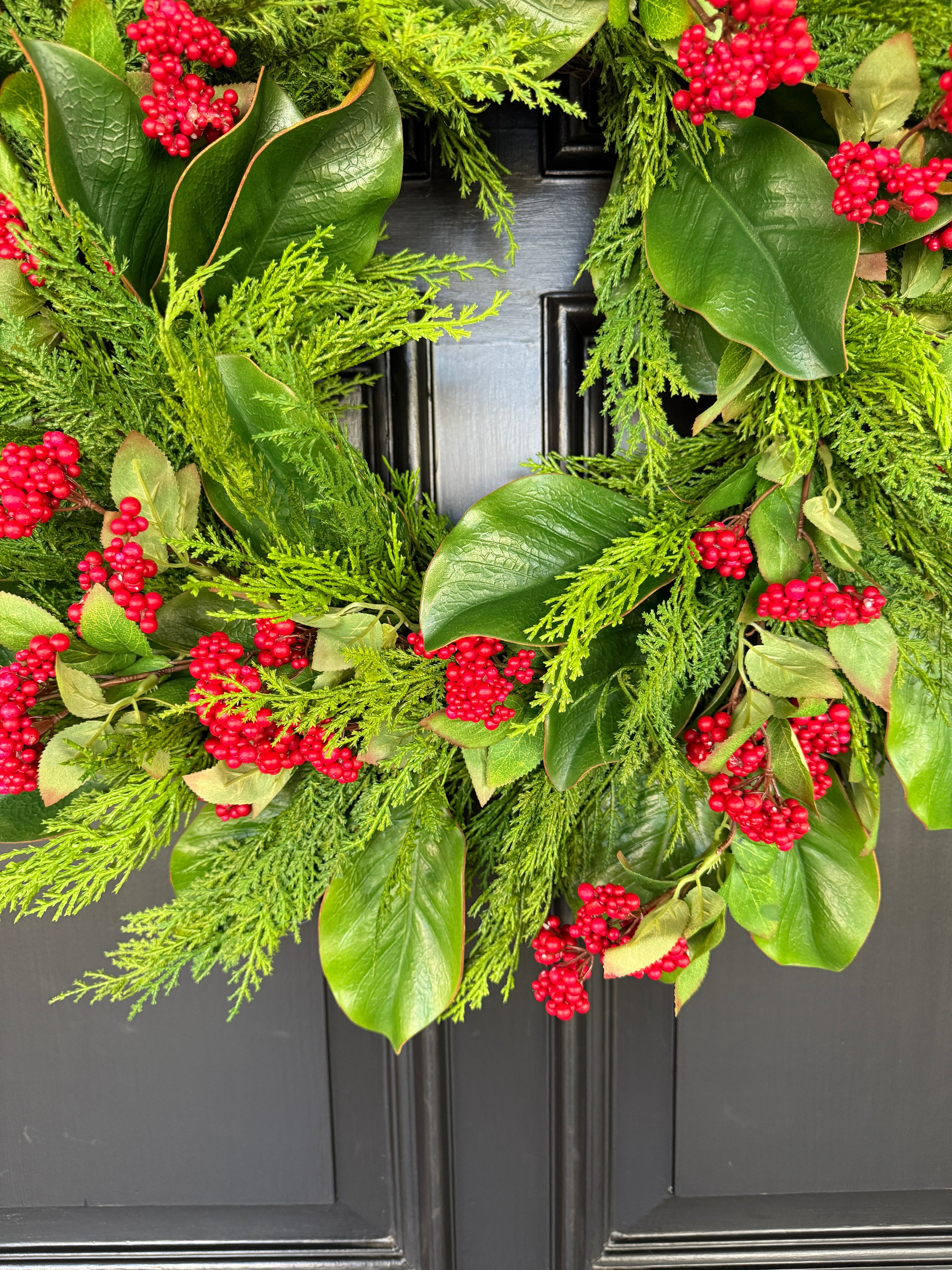 Red berry, cedar, and magnolia leaf wreath 27”