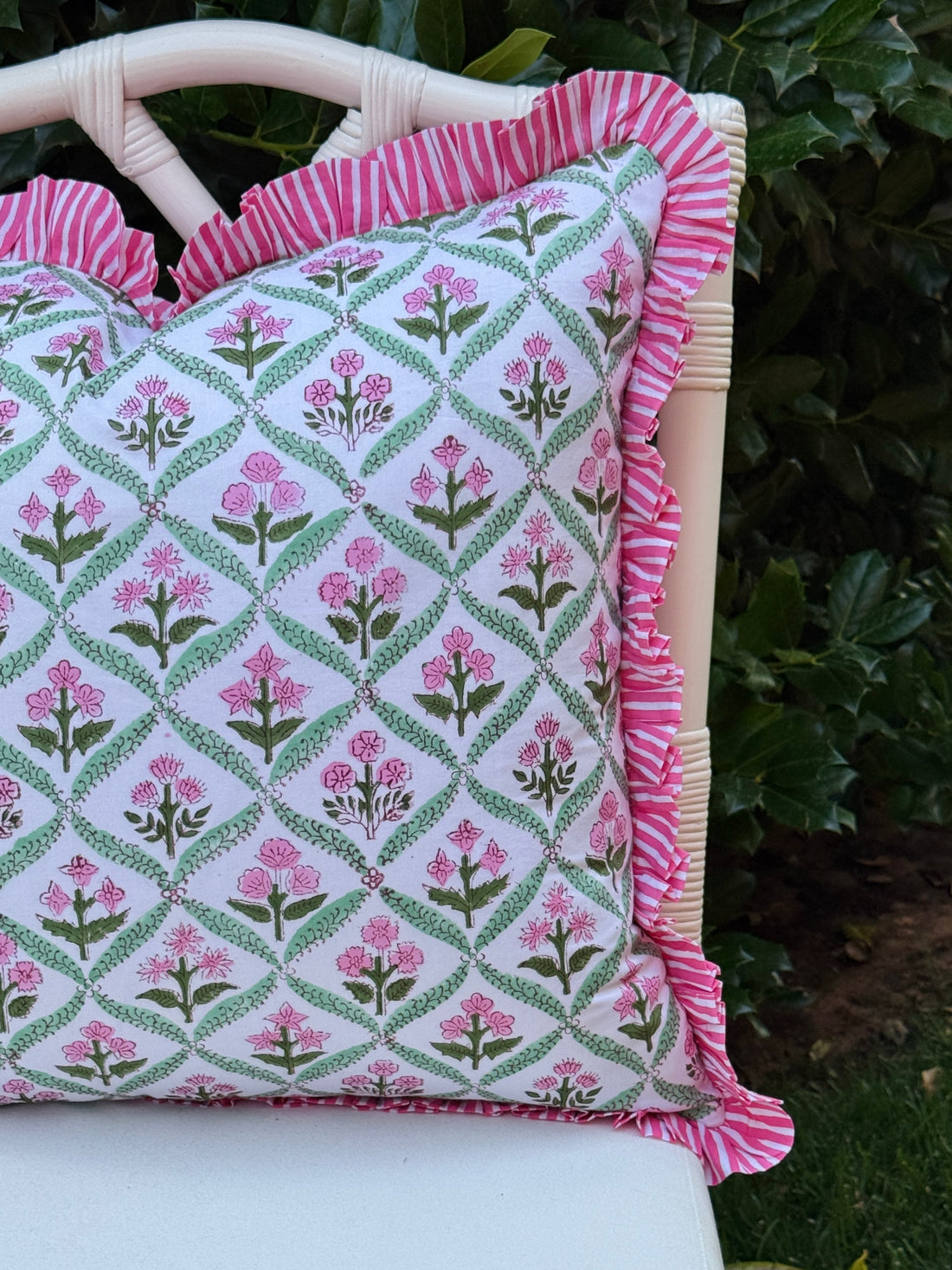 Pink and green floral trellis block print ruffle pillow cover with pink striped trim and back
