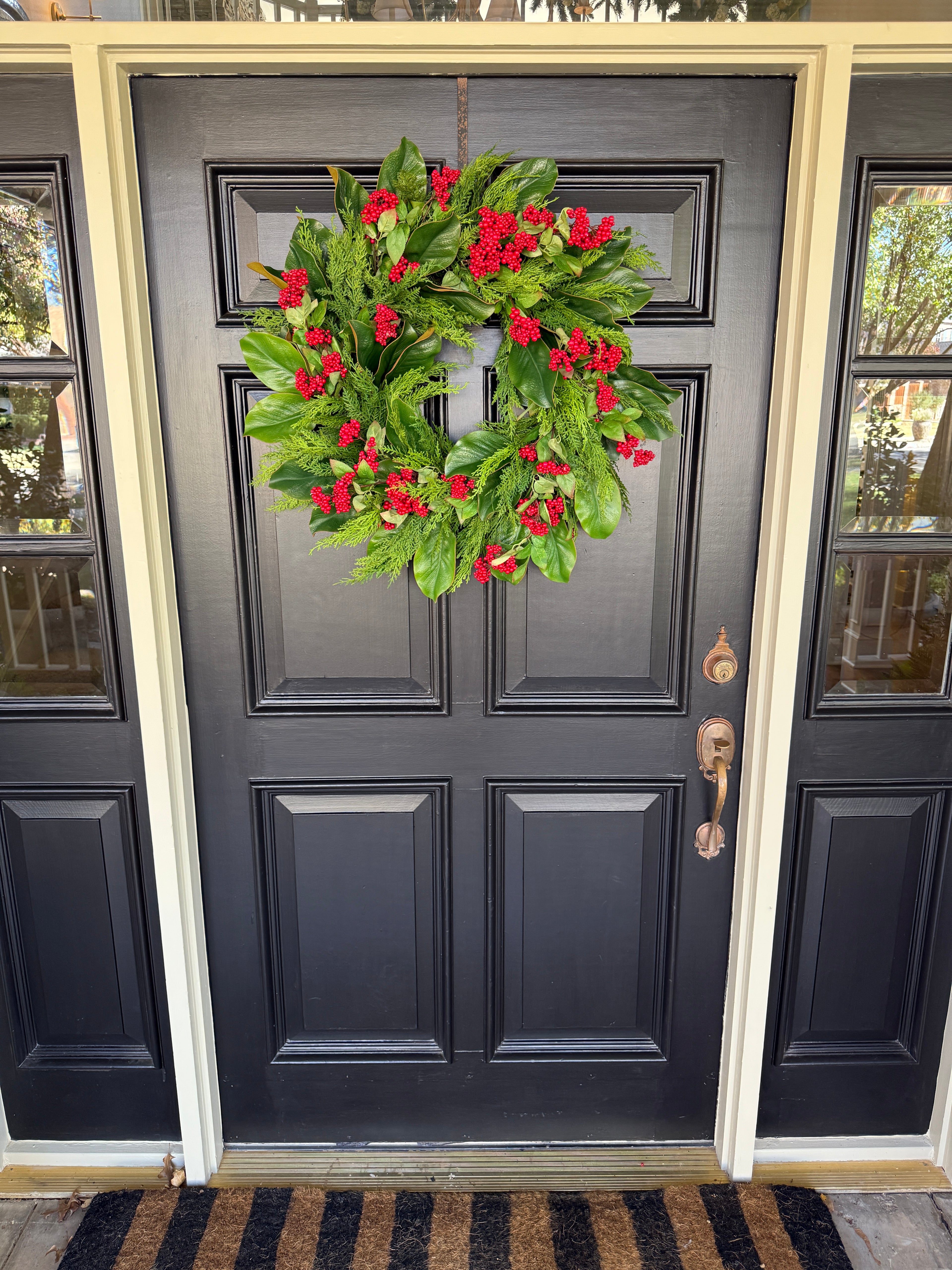 Red berry, cedar, and magnolia leaf wreath 27”