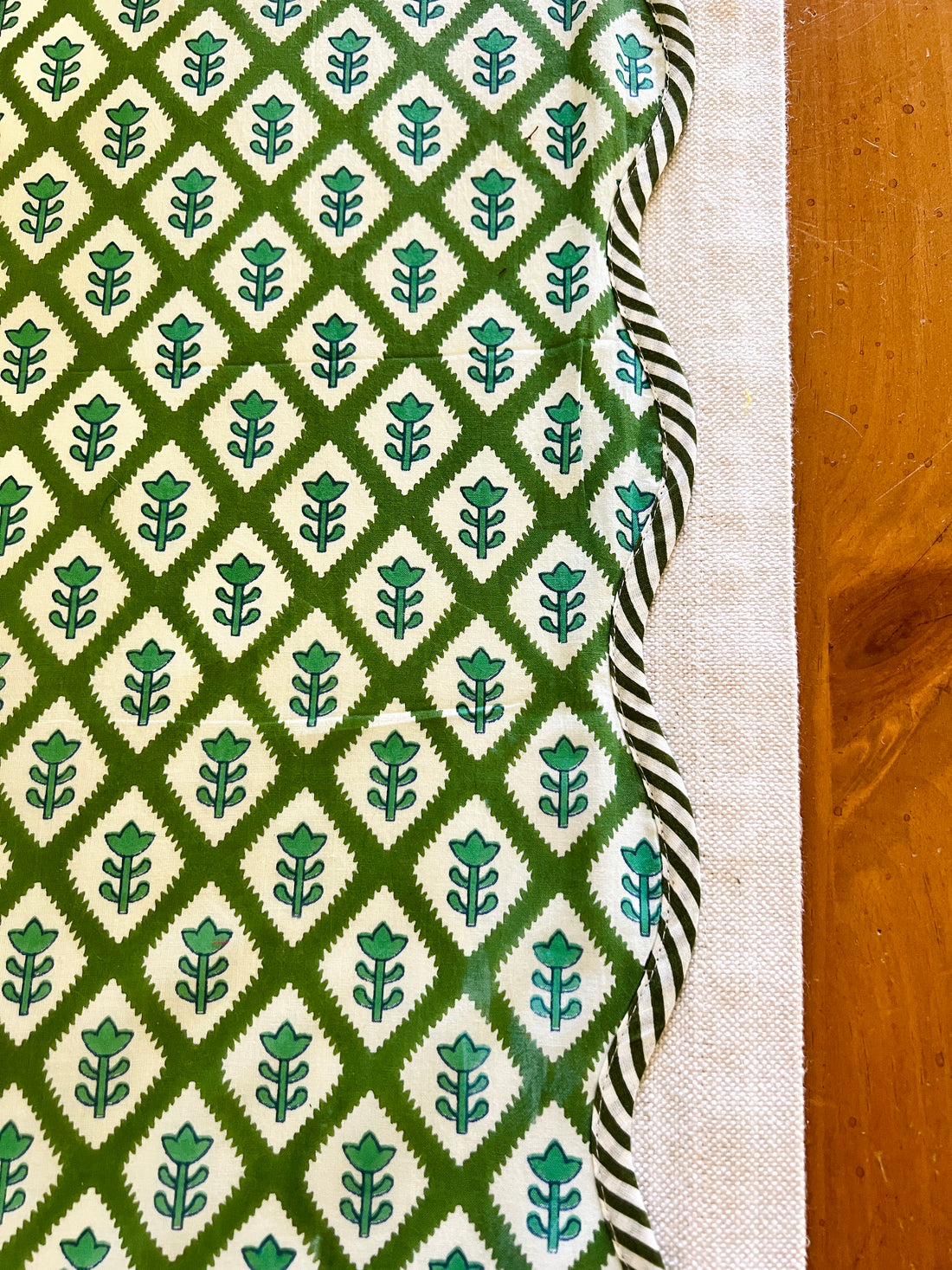 Green block print scalloped table runner with contrast piping