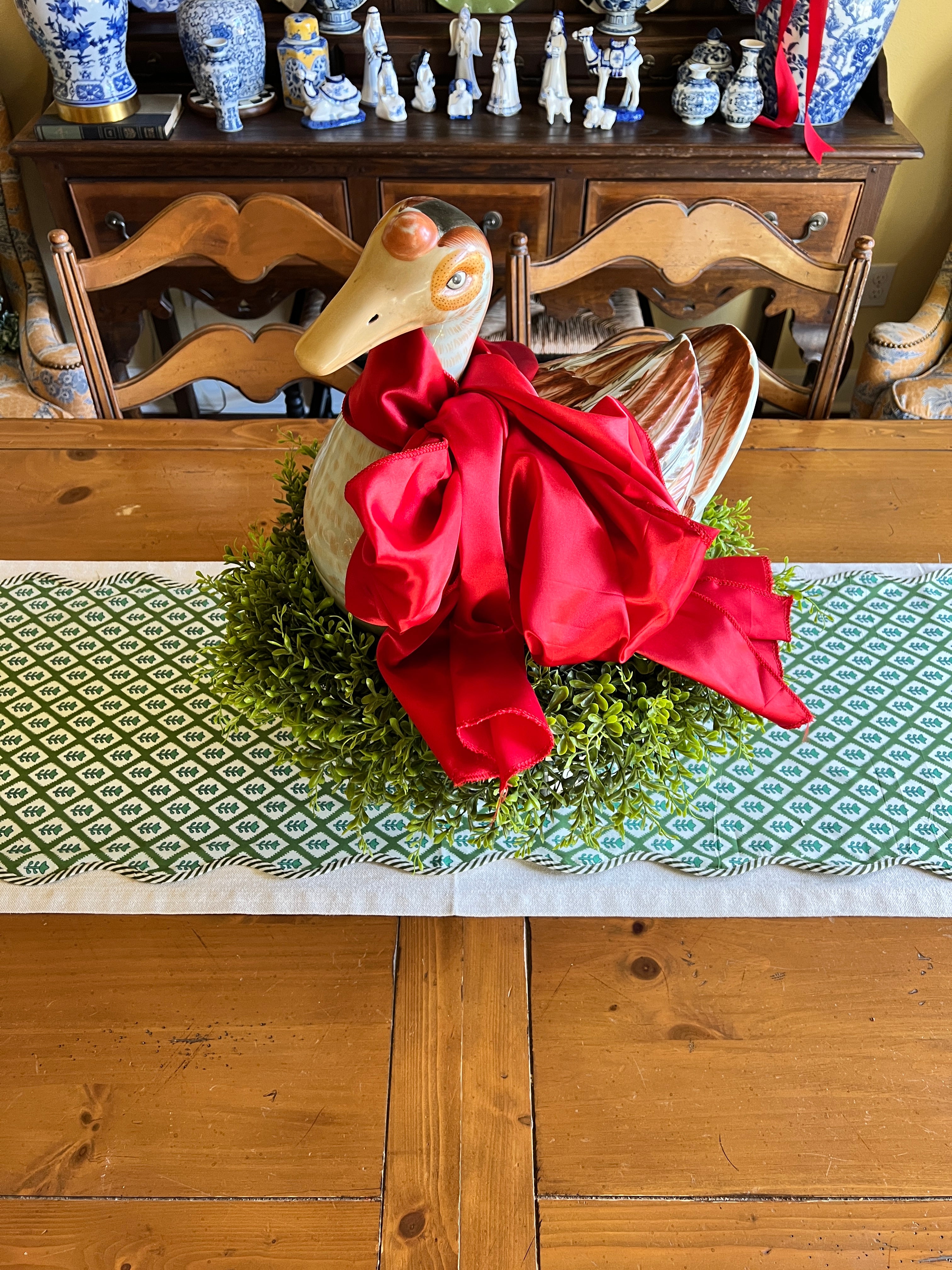 Green block print scalloped table runner with contrast piping
