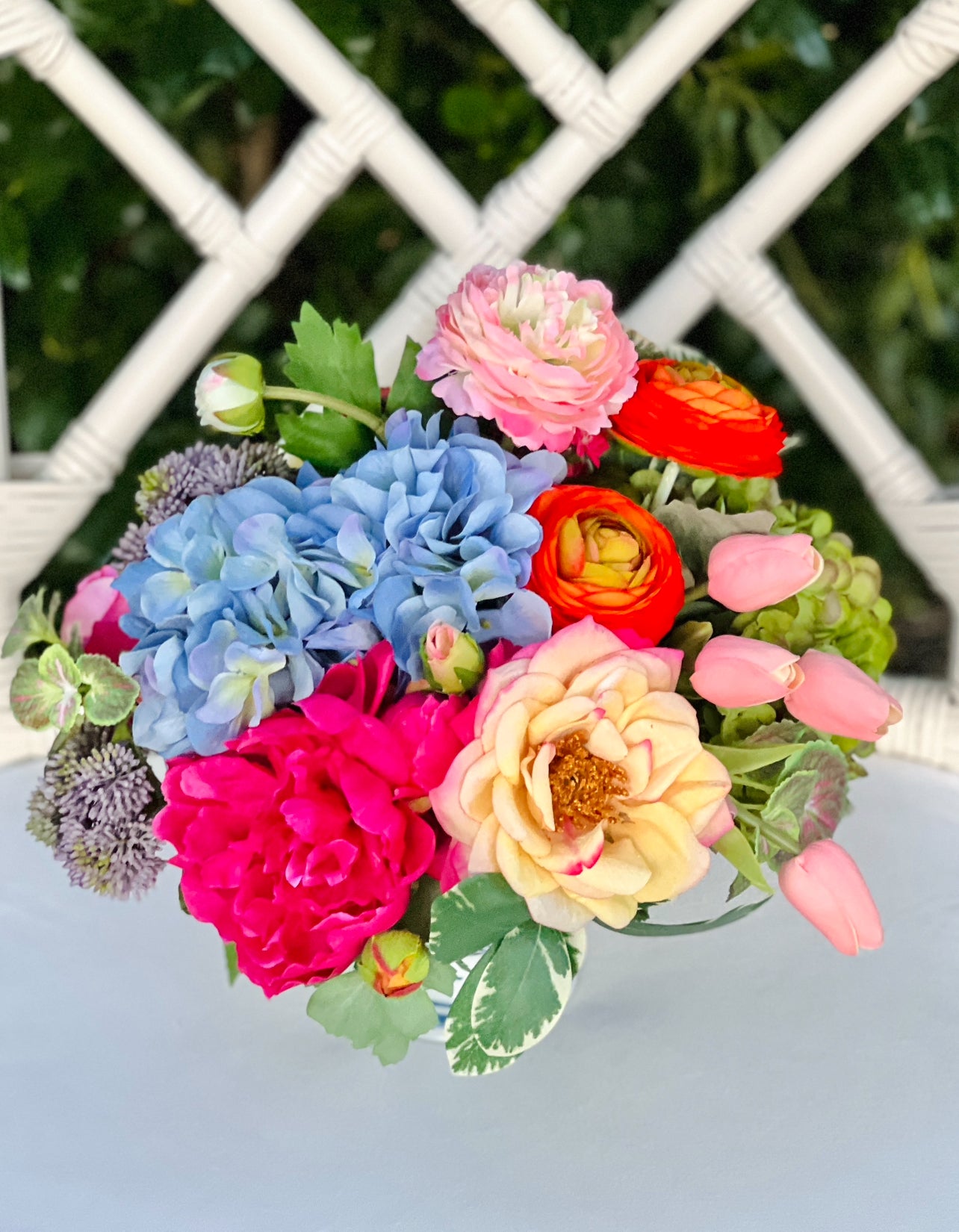 Bright mixed floral arrangement in chinoiserie footed bowl