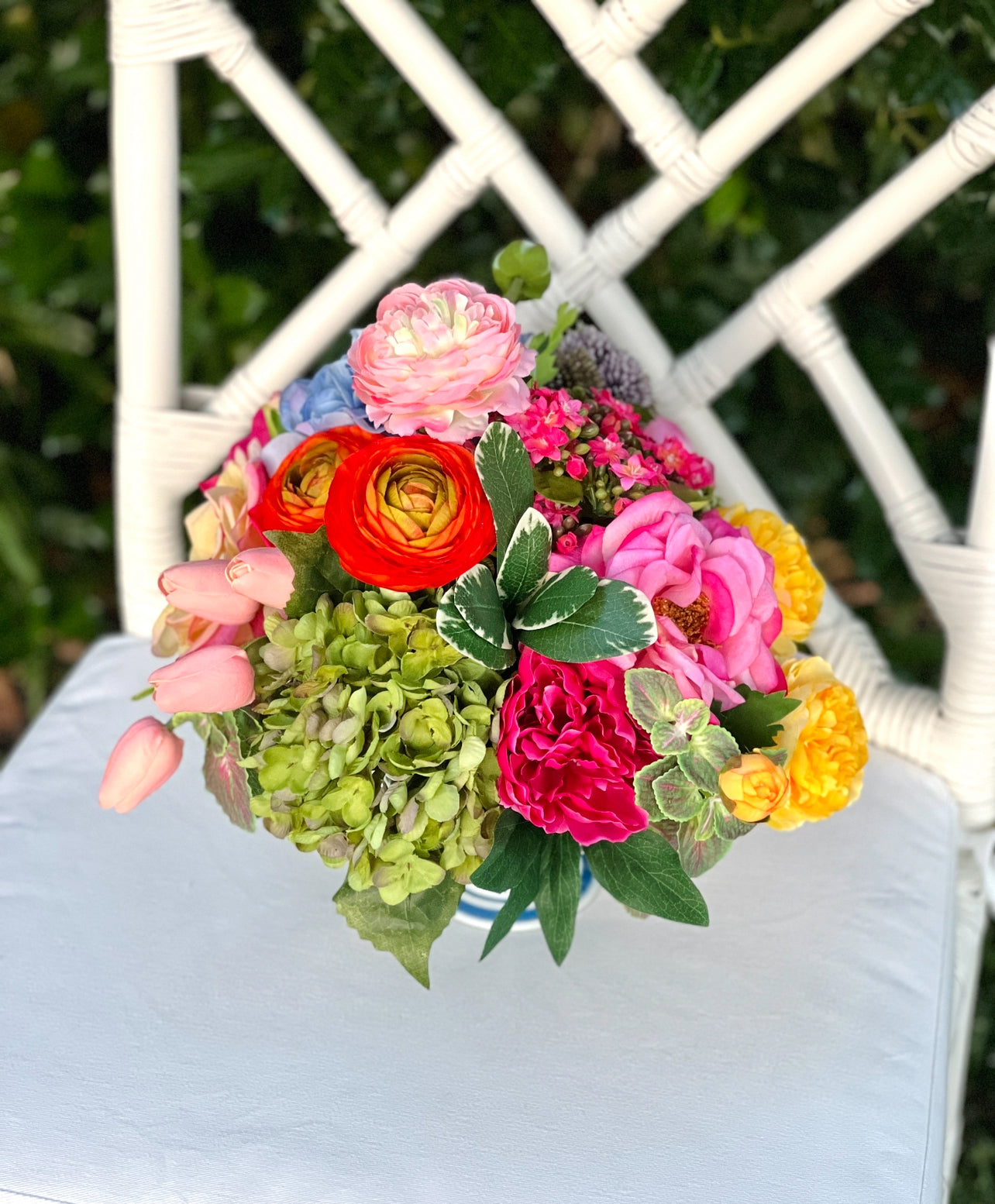 Bright mixed floral arrangement in chinoiserie footed bowl