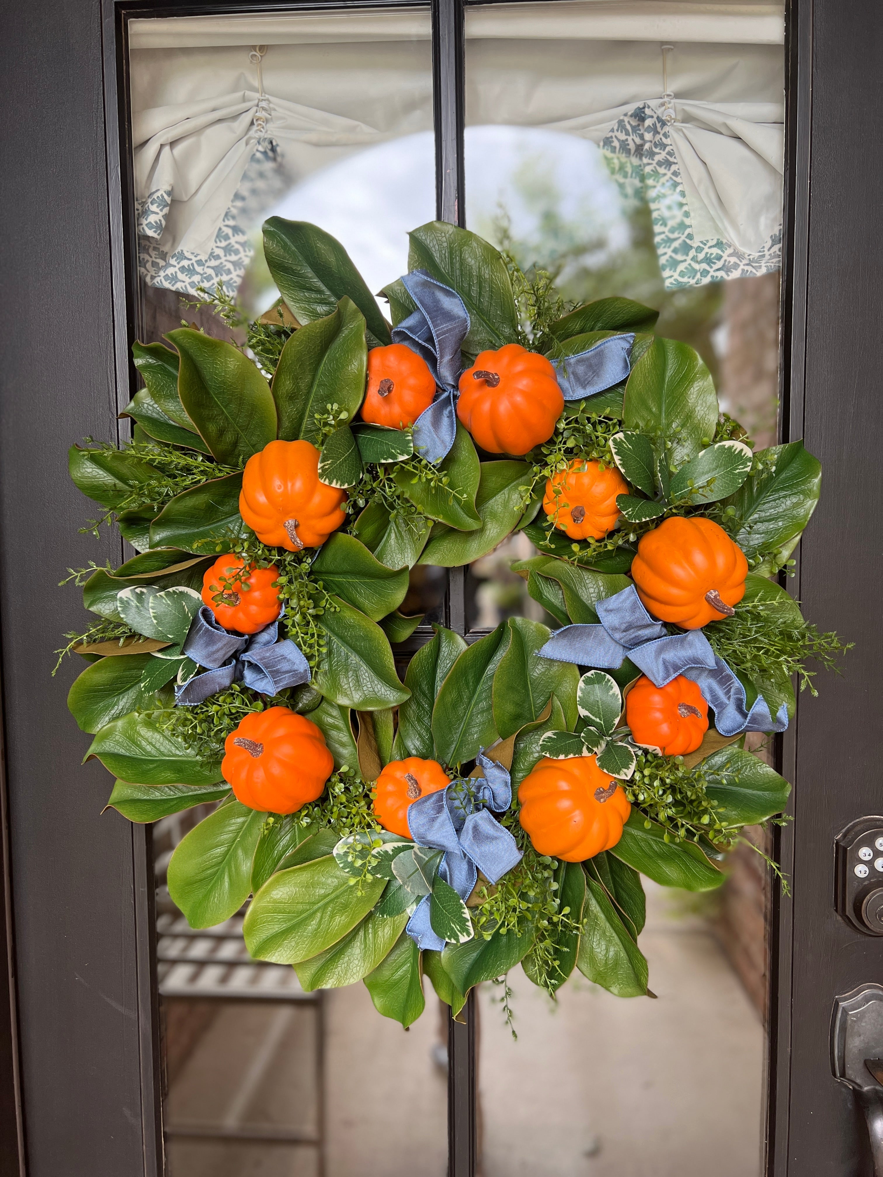 Fall orange pumpkin and magnolia wreath with French blue ribbons