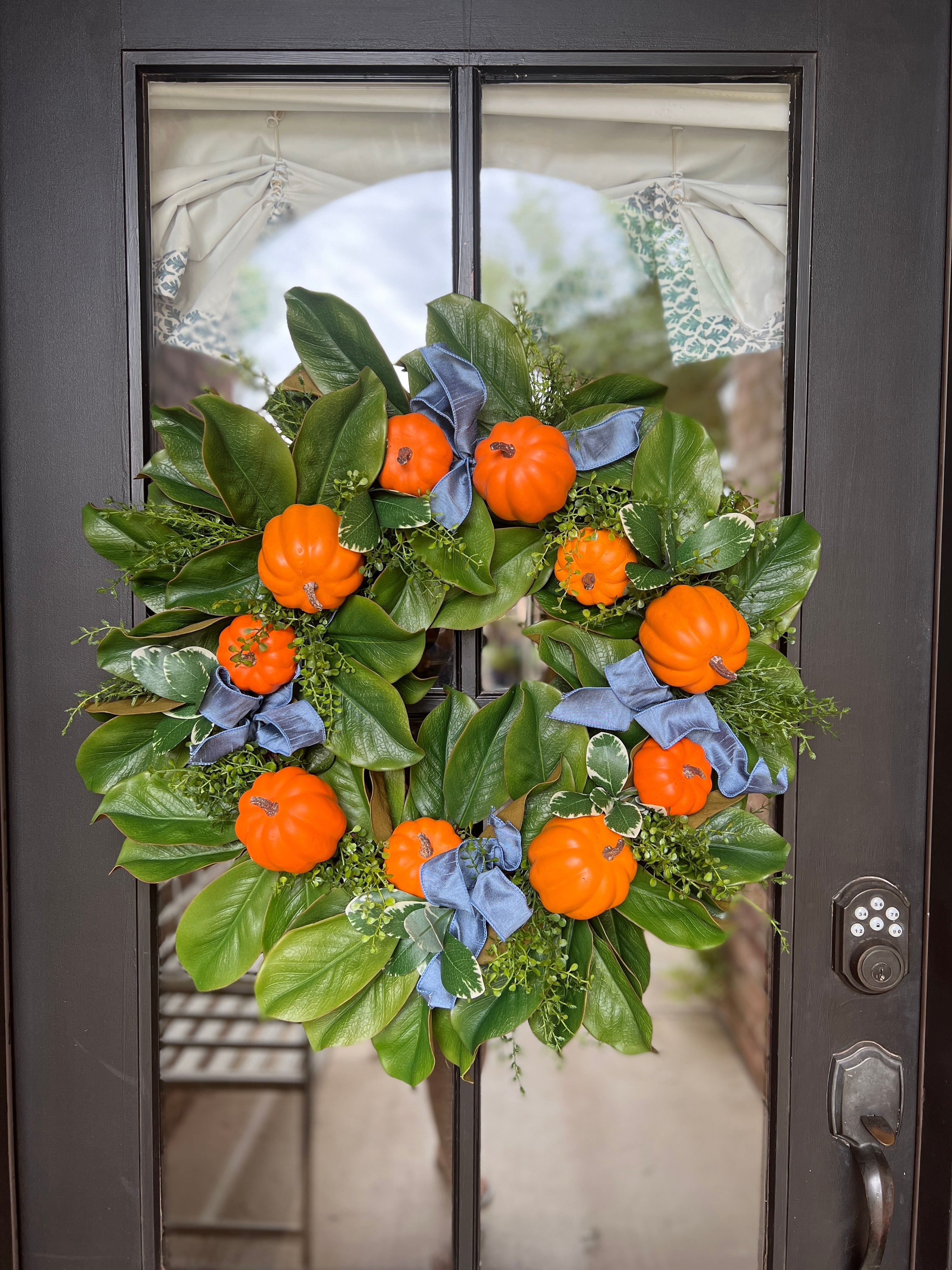 Fall orange pumpkin and magnolia wreath with French blue ribbons