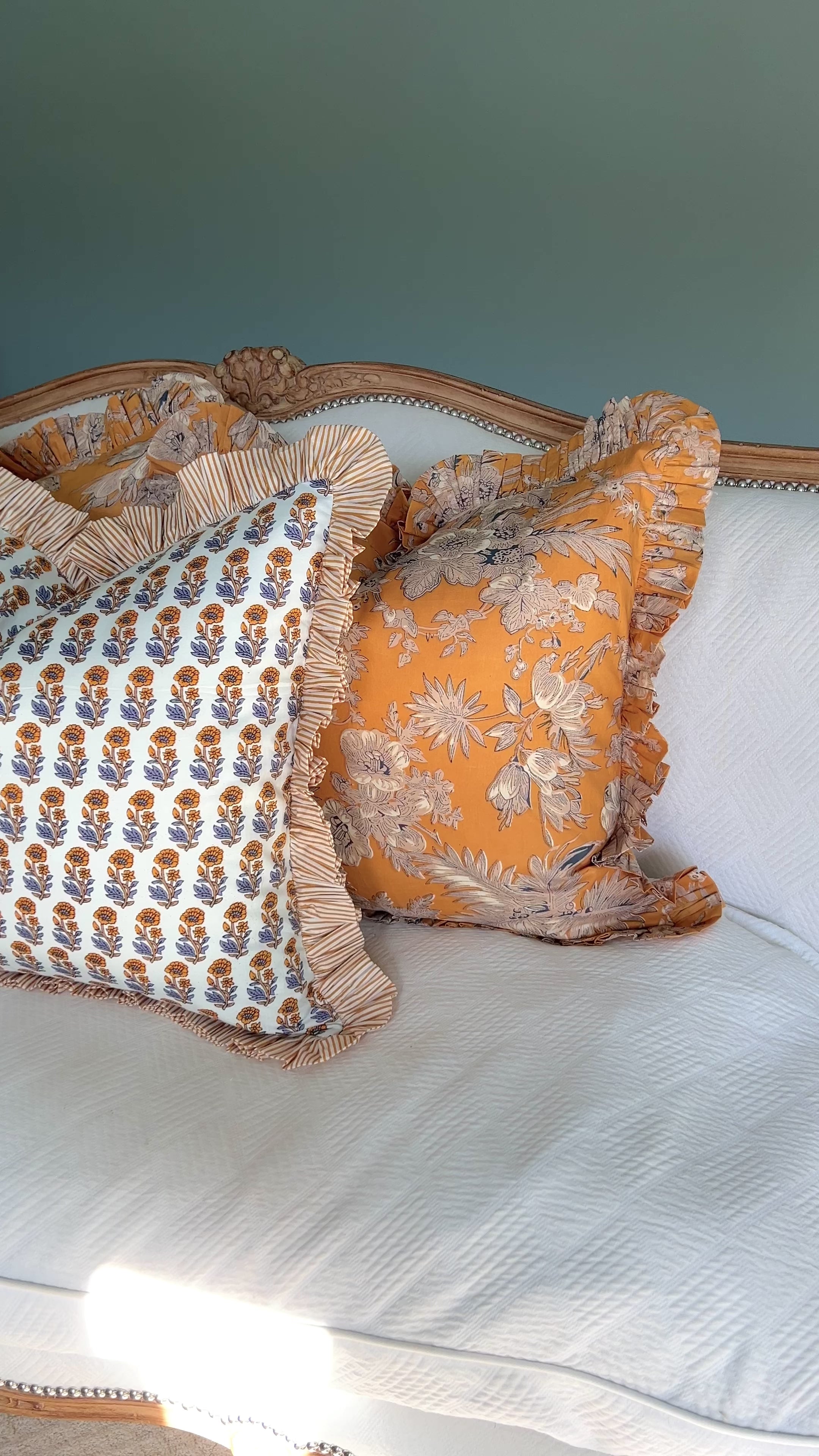 Yellow and blue block print pillow cover with striped contrast ruffle