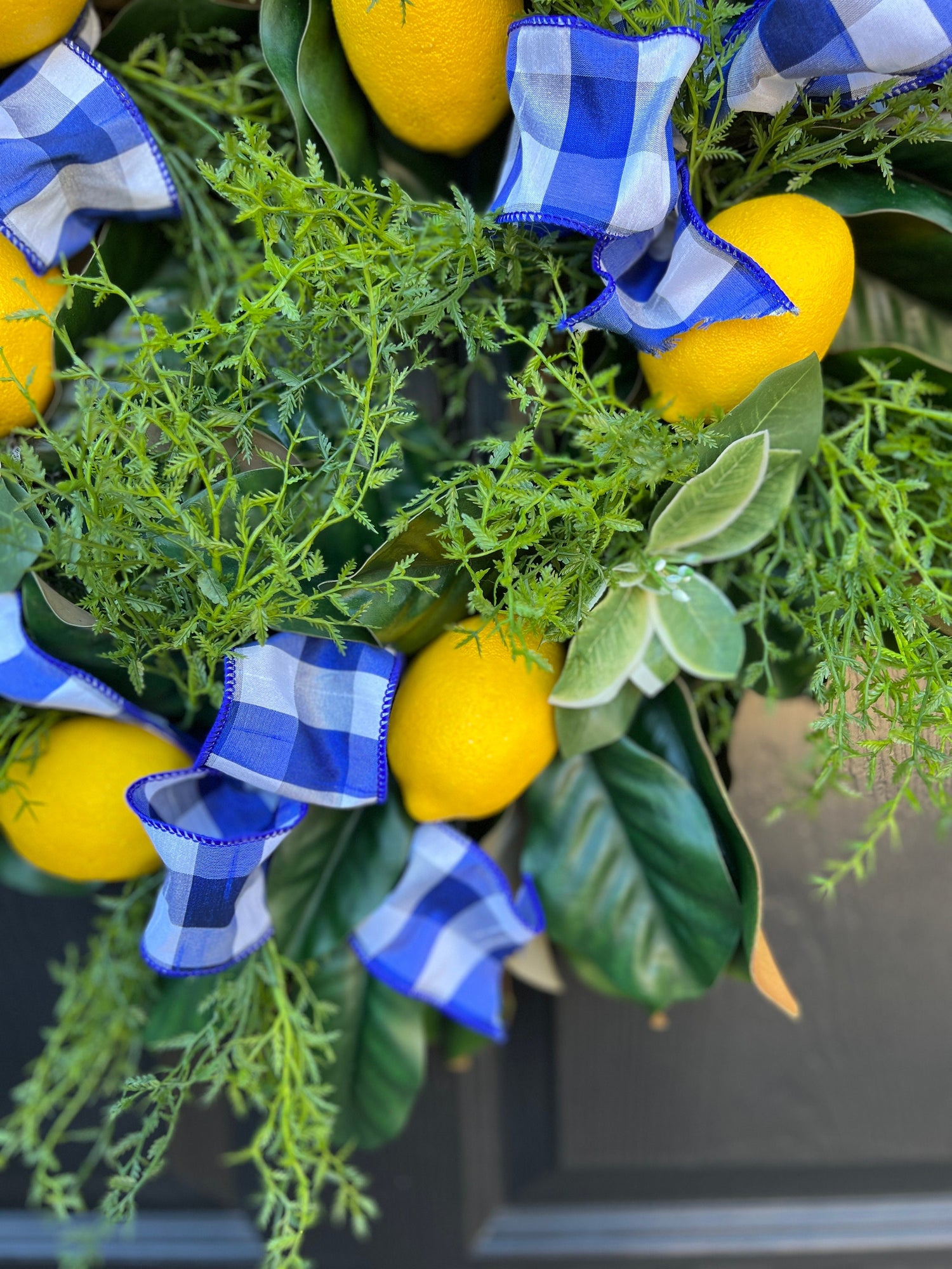 Lemon, herb, and magnolia wreath with blue gingham dupioni ribbon