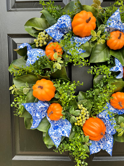 Orange pumpkin wreath with blue and white chinoiserie ribbon