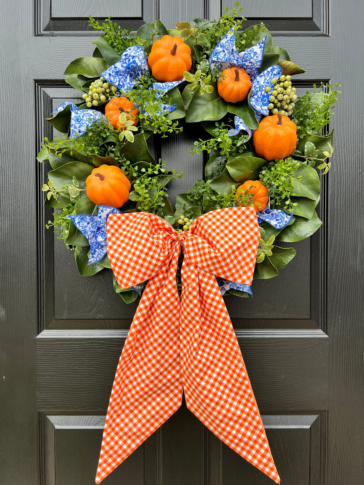 Orange pumpkin wreath with blue and white chinoiserie ribbon