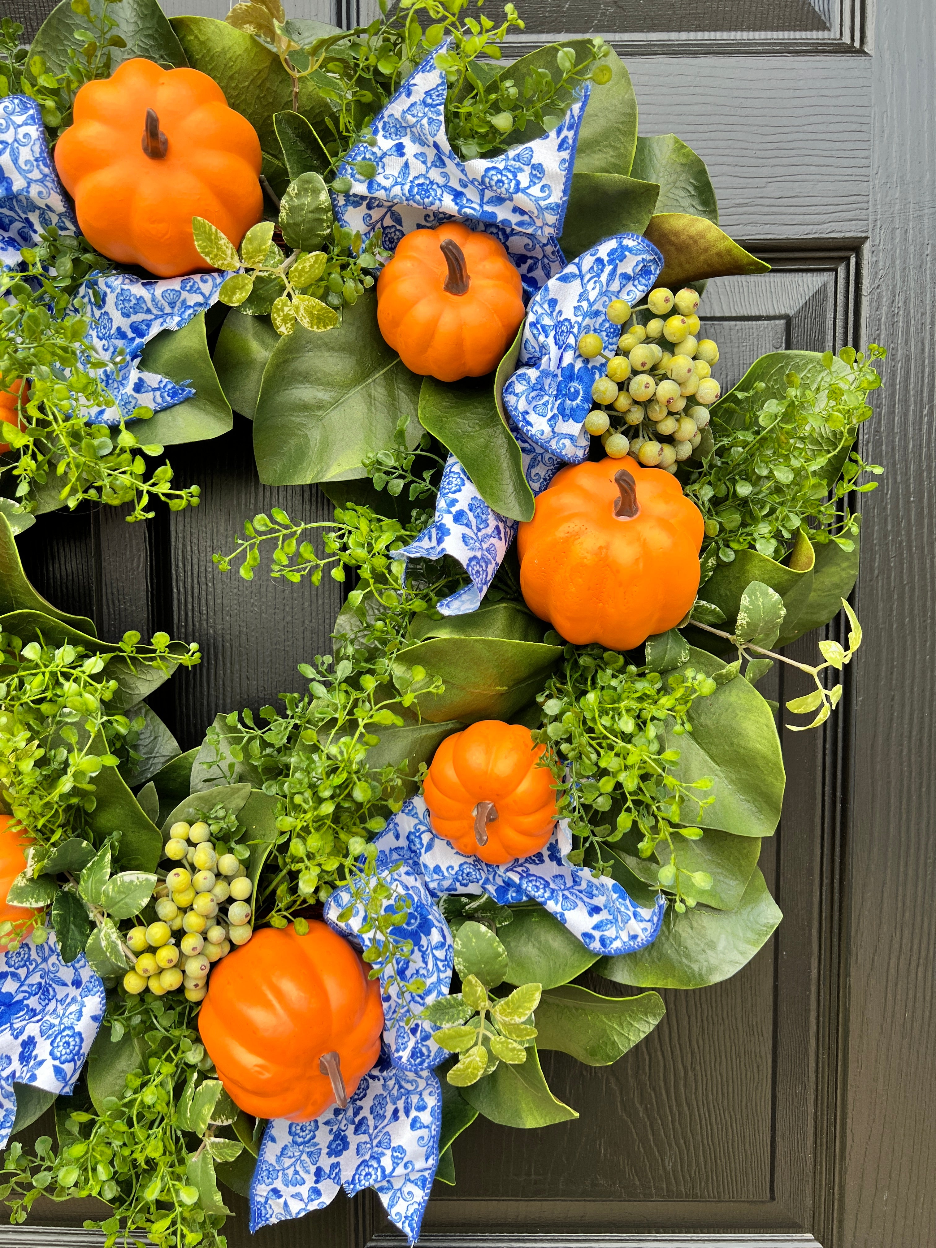 Orange pumpkin wreath with blue and white chinoiserie ribbon