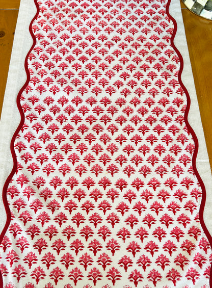 Red block print scalloped table runner with contrast piping