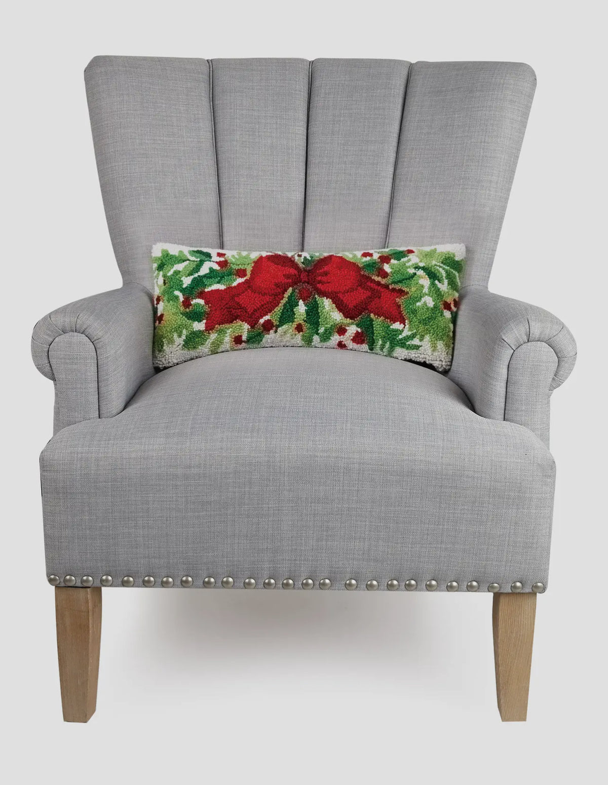 Red bow and greenery hand hooked lumbar pillow
