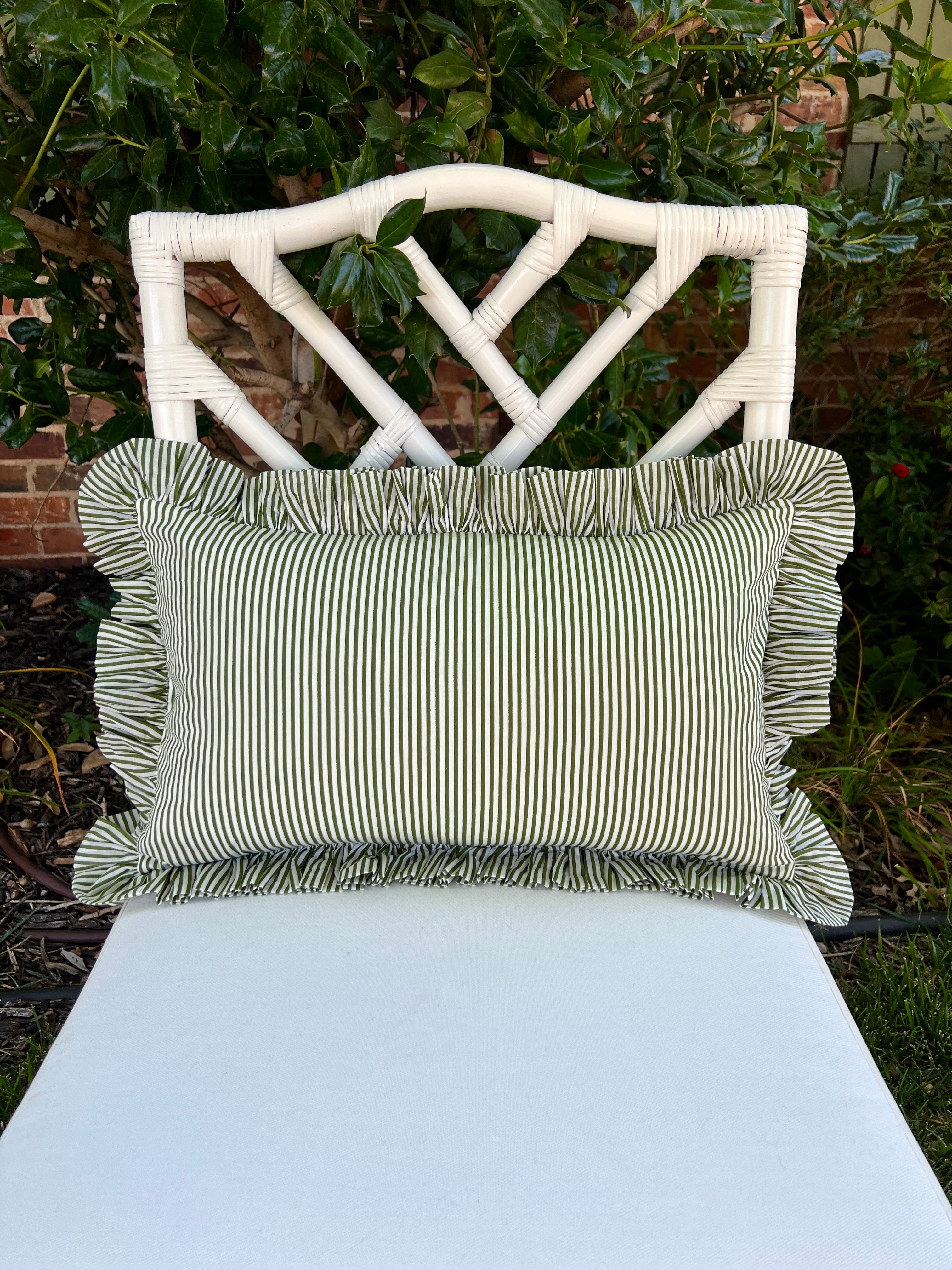 Green and white striped pillow cover with ruffle trim