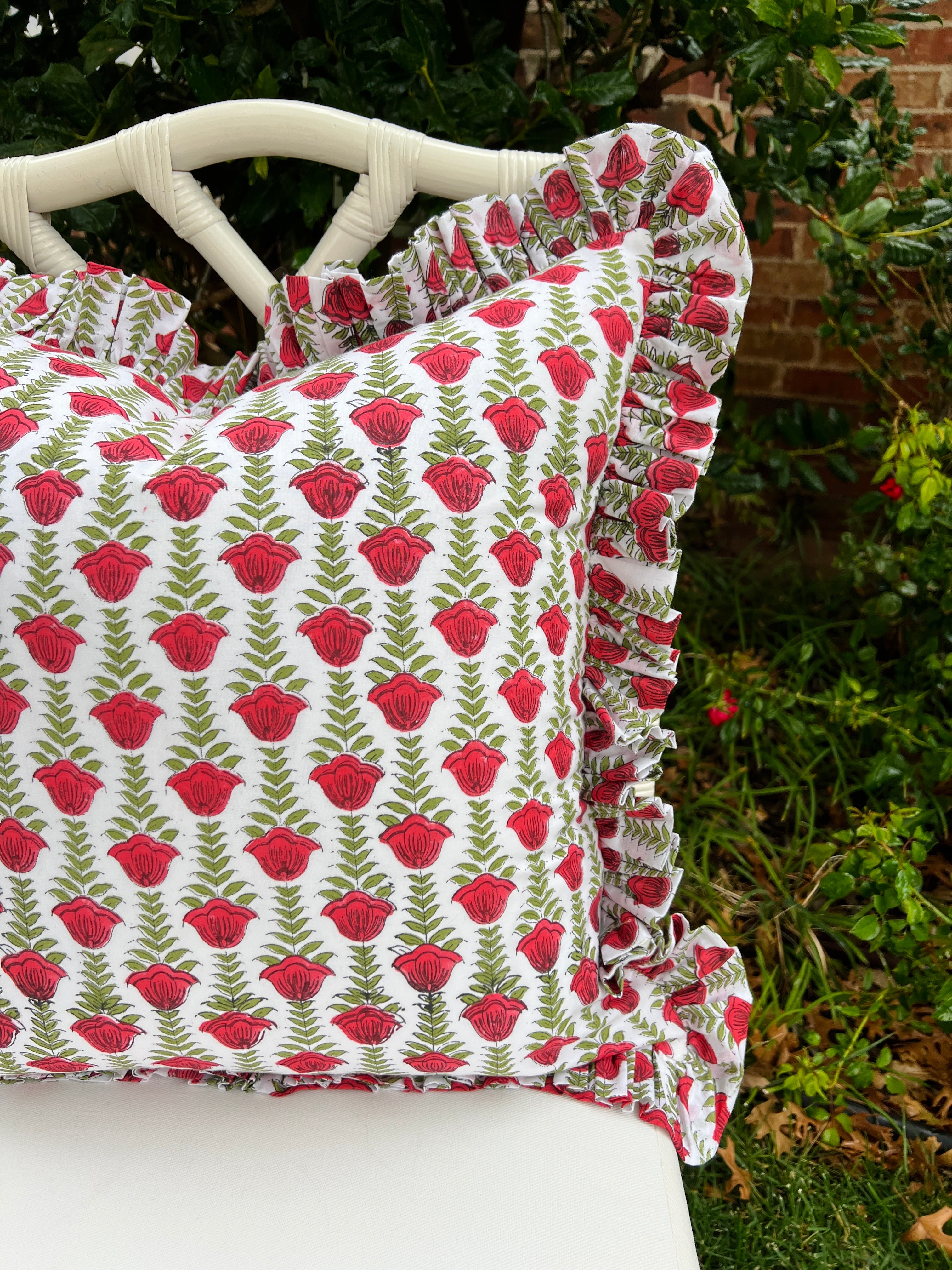 Red and green block print pillow cover with ruffle trim