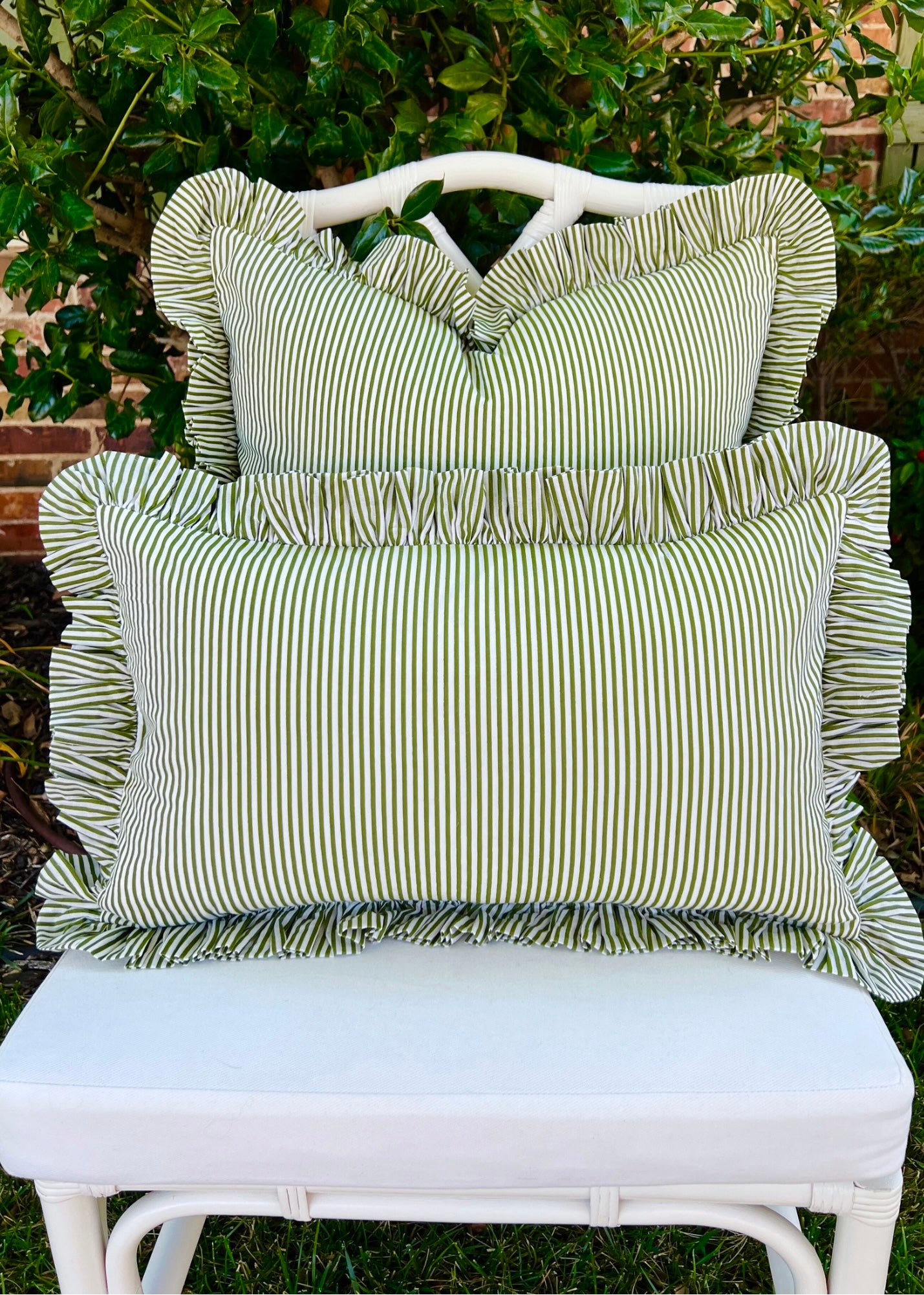 Green and white striped pillow cover with ruffle trim