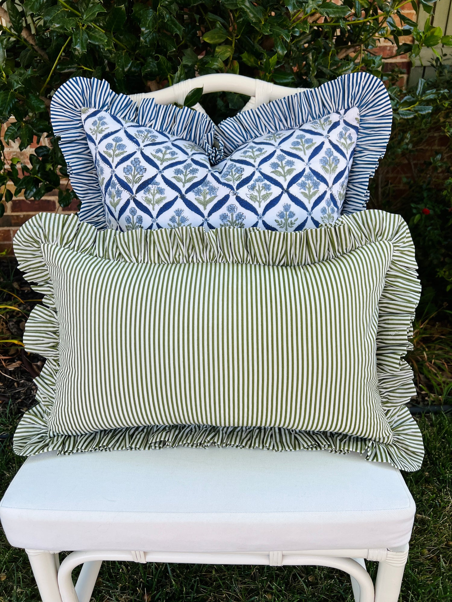 Green and white striped pillow cover with ruffle trim