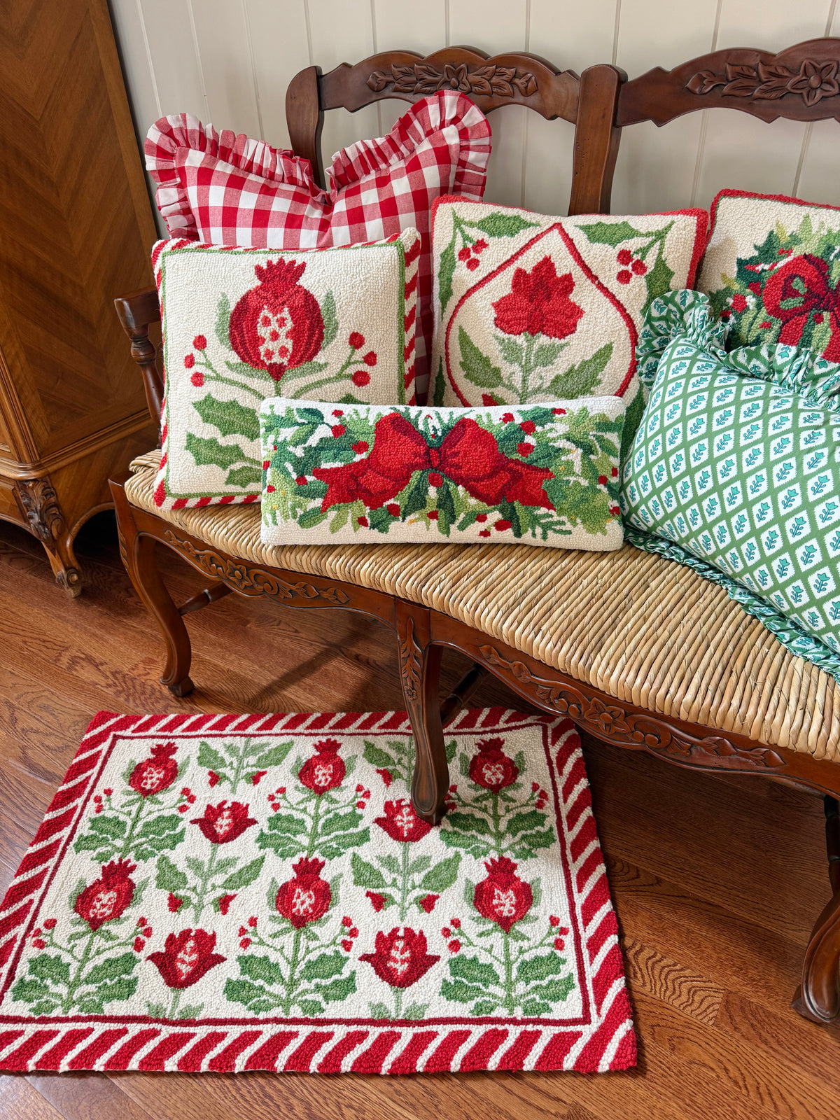 Red bow and greenery hand hooked lumbar pillow