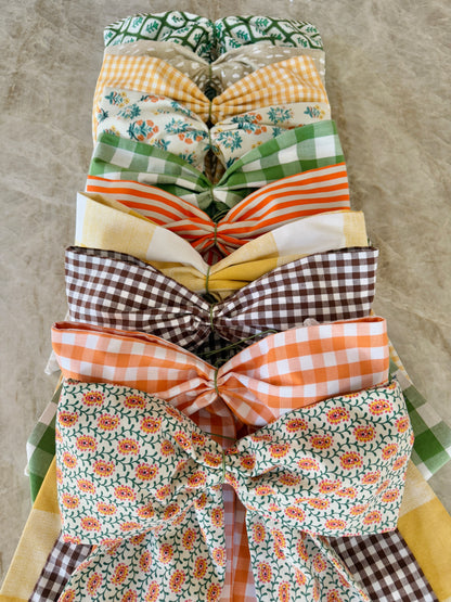 Green block print wreath sash with striped piping