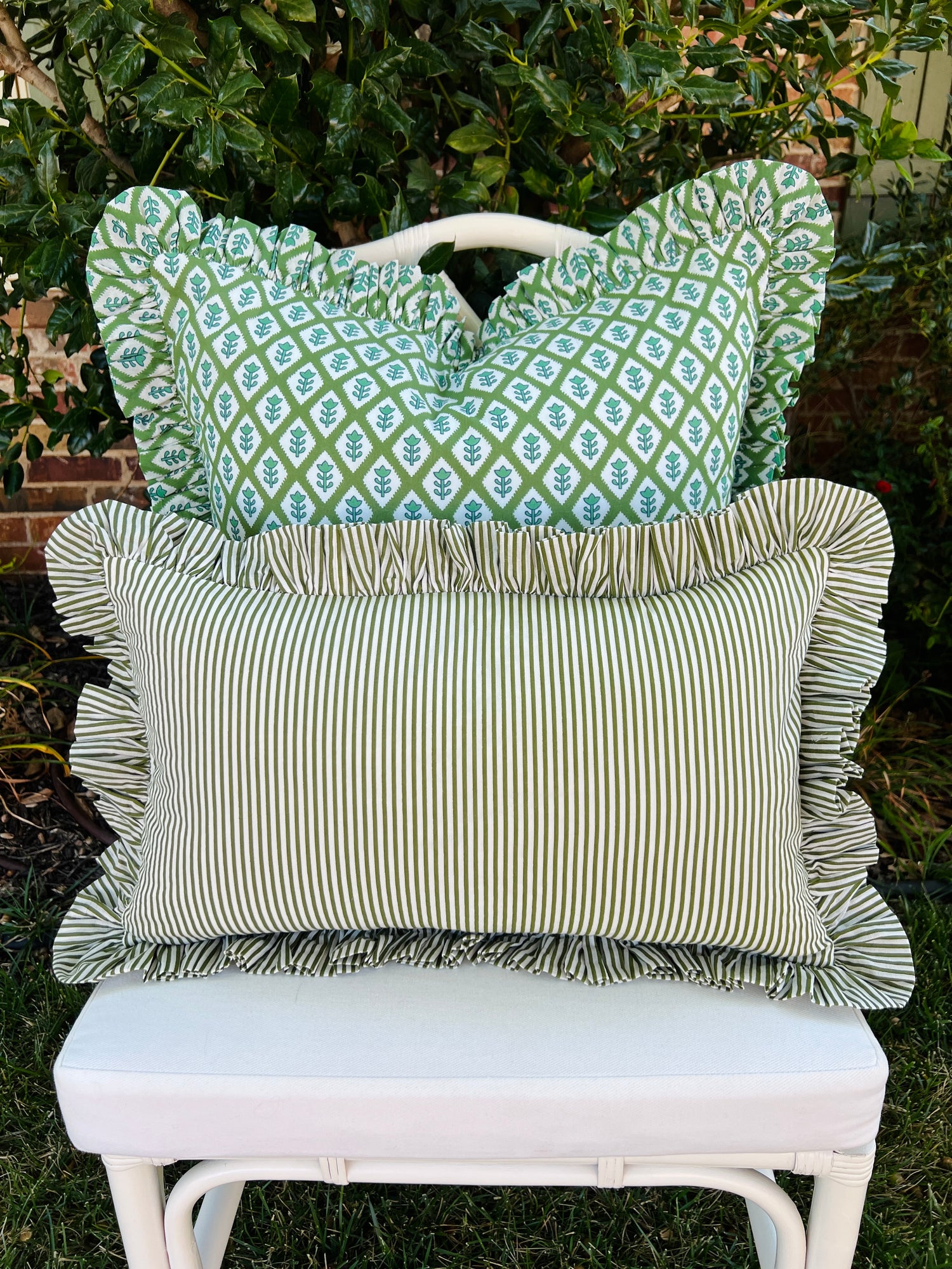 Green and white striped pillow cover with ruffle trim