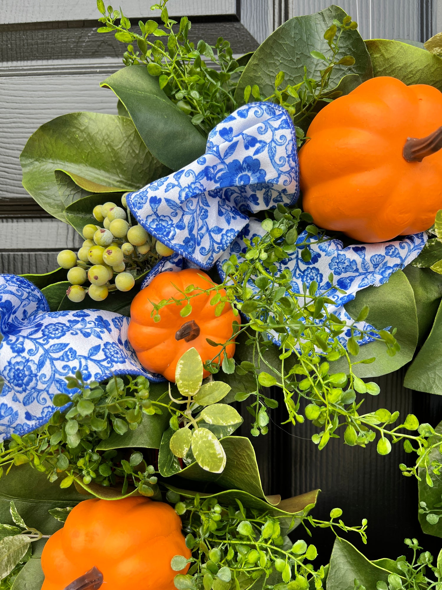 Orange pumpkin wreath with blue and white chinoiserie ribbon