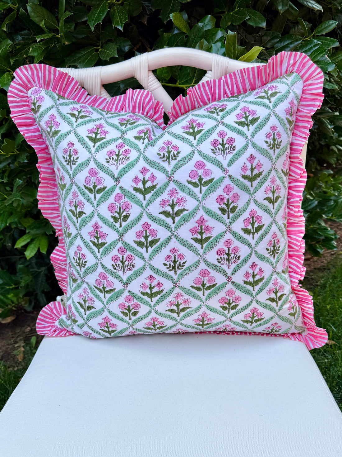 Pink and green floral trellis block print ruffle pillow cover with pink striped trim and back