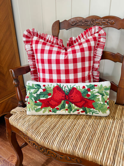 Red bow and greenery hand hooked lumbar pillow