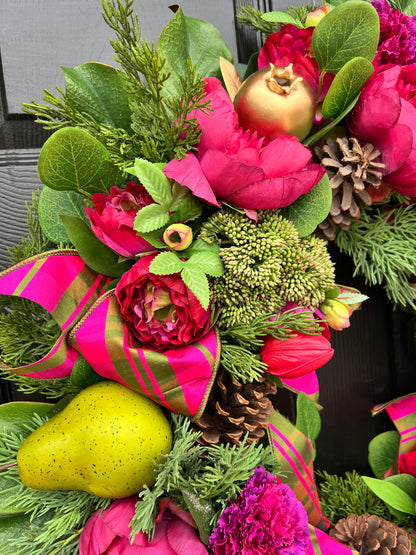 Lush fuchsia and green floral and fruit winter wreath