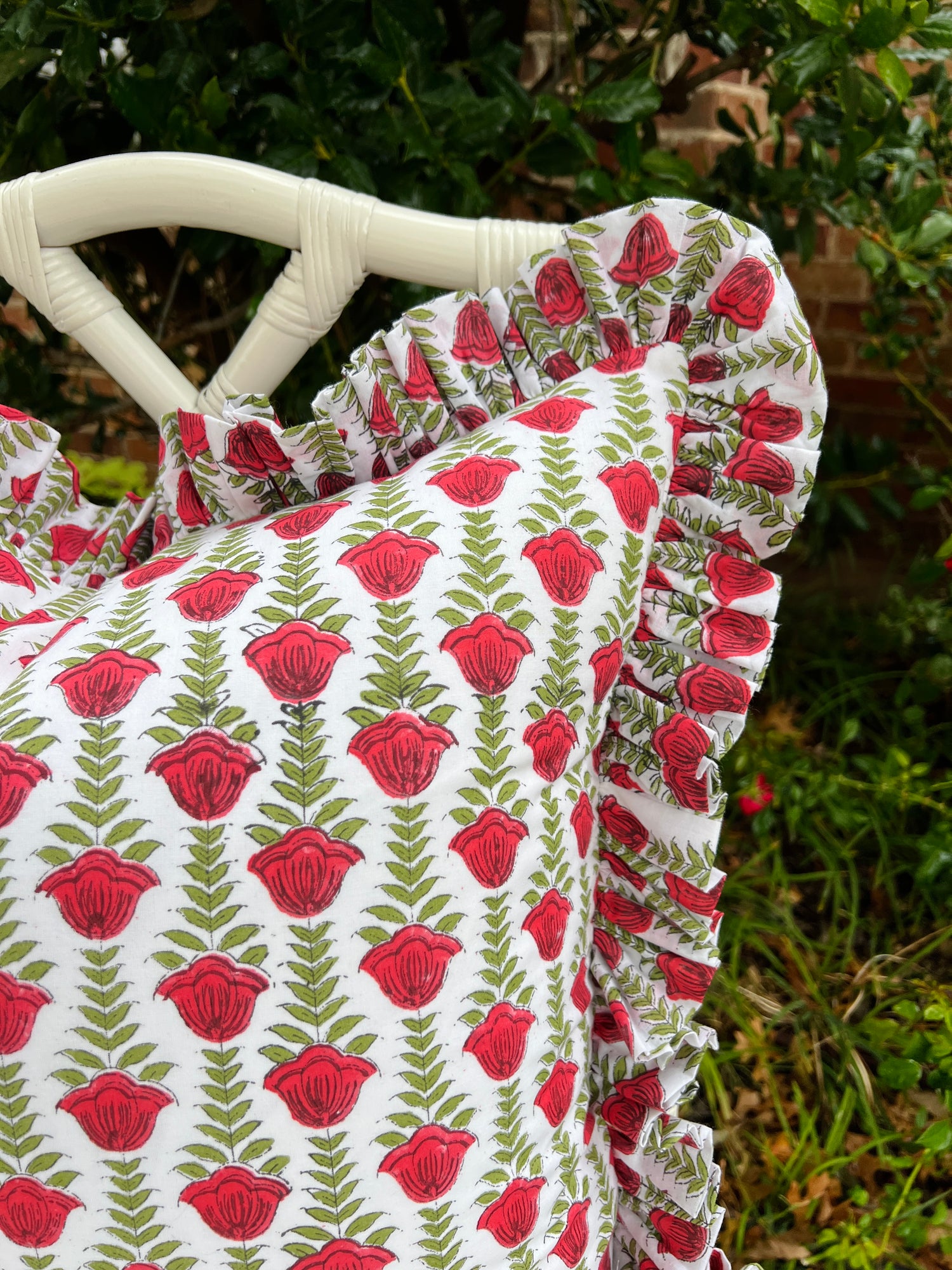 Red and green block print pillow cover with ruffle trim