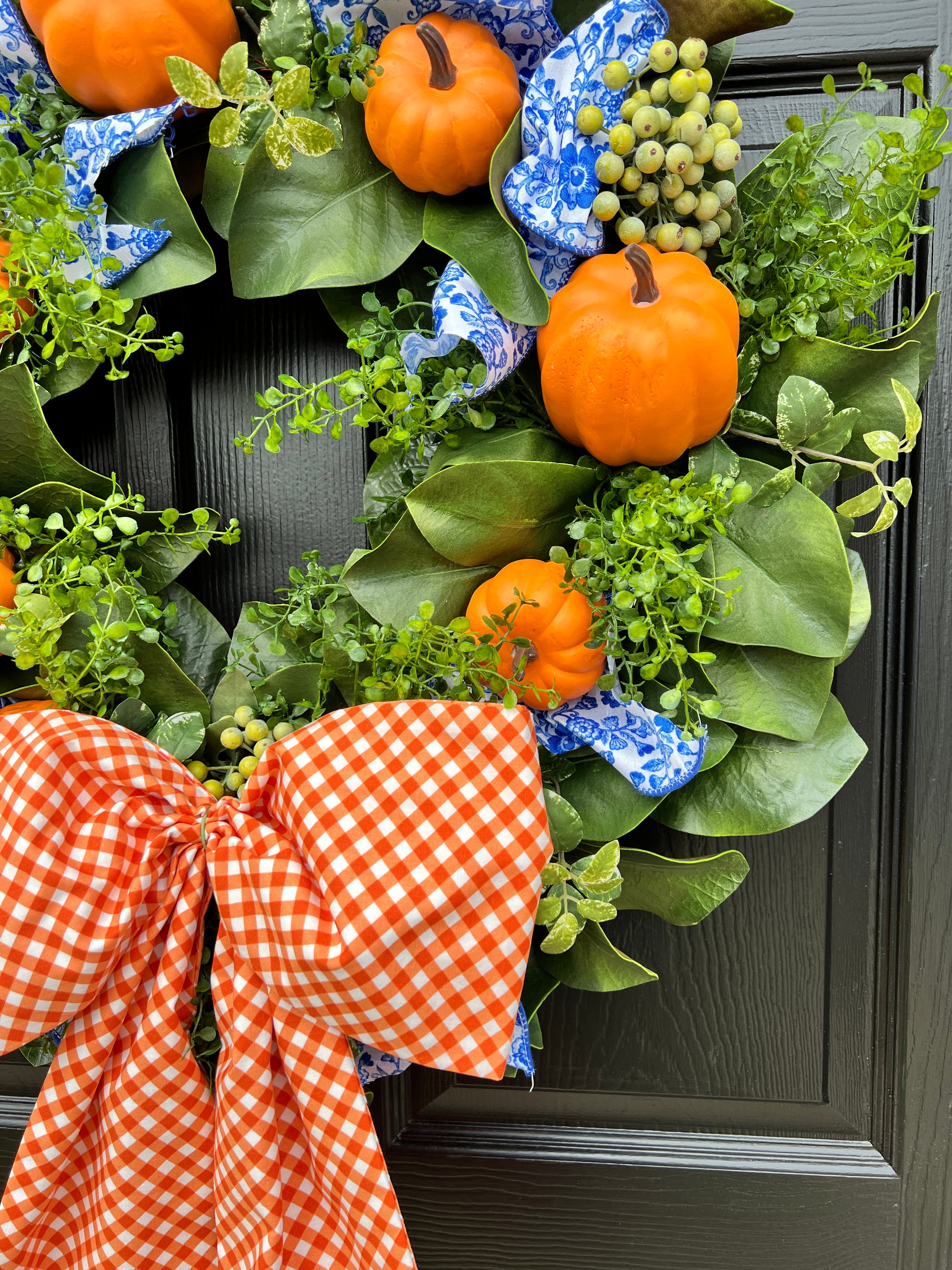 Orange pumpkin wreath with blue and white chinoiserie ribbon