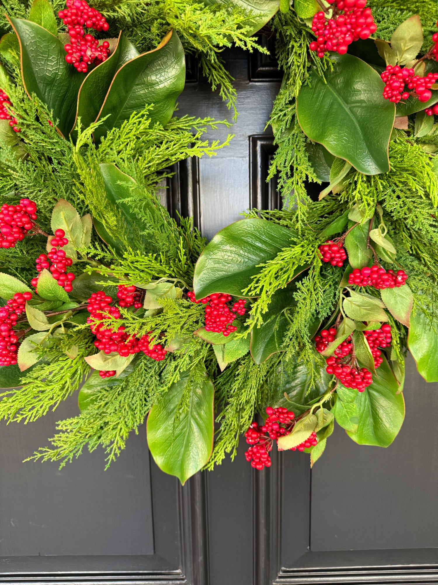 Red berry, cedar, and magnolia leaf wreath 27”