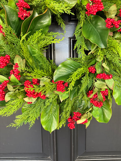 Red berry, cedar, and magnolia leaf wreath 27”