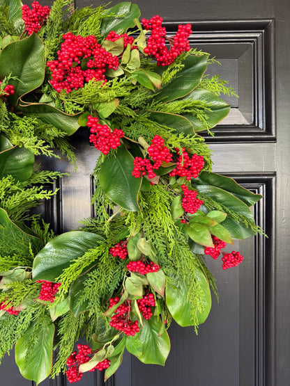 Red berry, cedar, and magnolia leaf wreath 27”