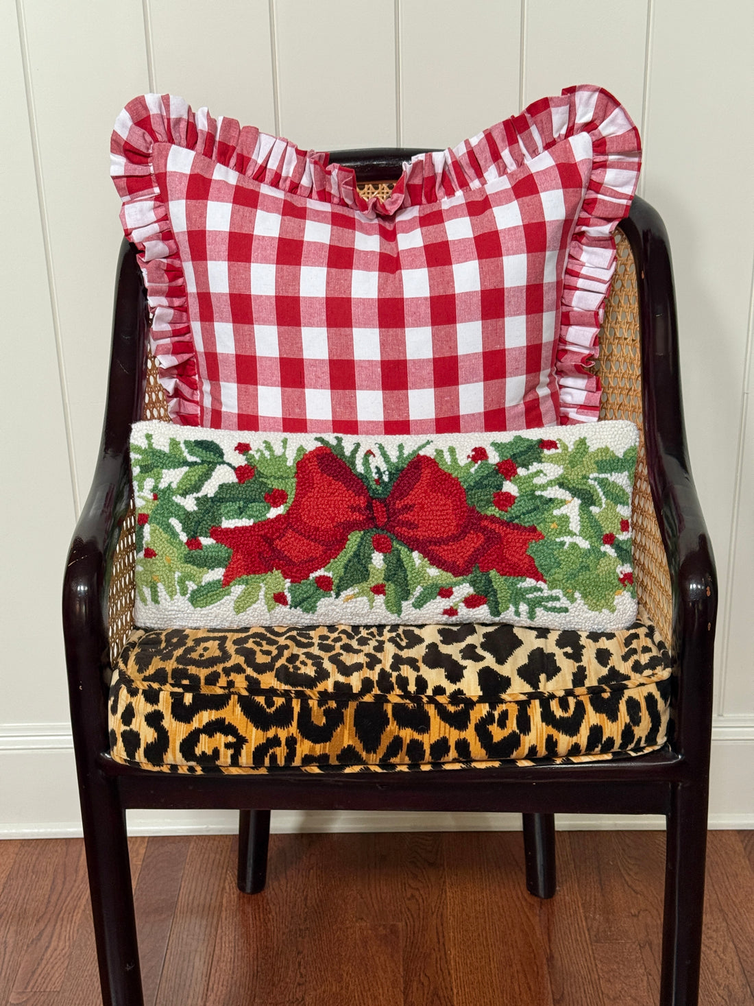 Red bow and greenery hand hooked lumbar pillow