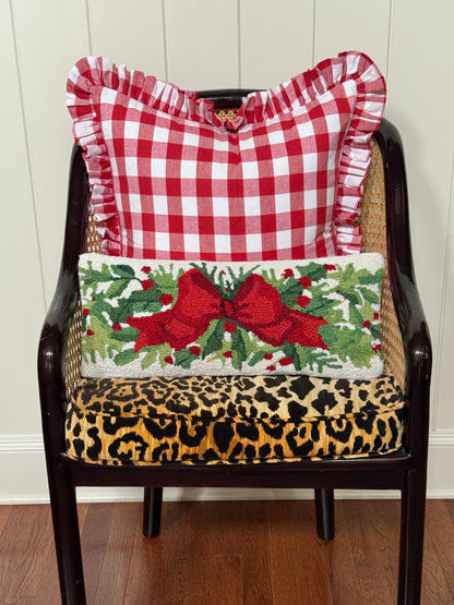 Red bow and greenery hand hooked lumbar pillow