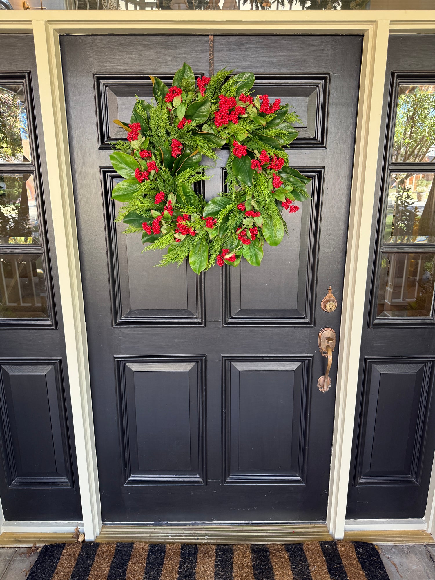 Red berry, cedar, and magnolia leaf wreath 27”