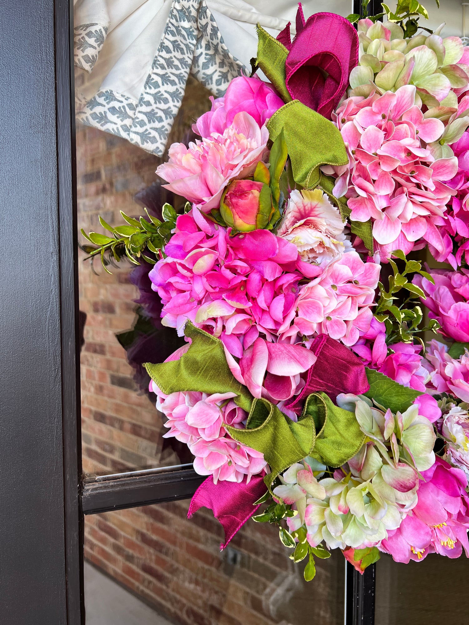 Spring pink and green hydrangea, peony, and cabbage wreath