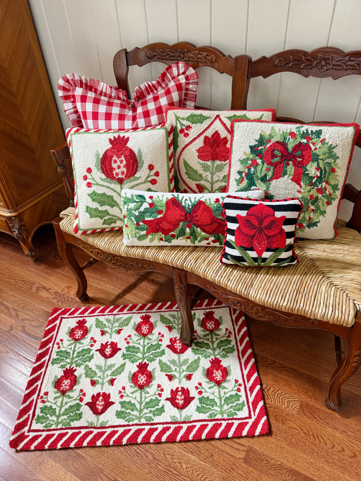 Red bow and greenery hand hooked lumbar pillow