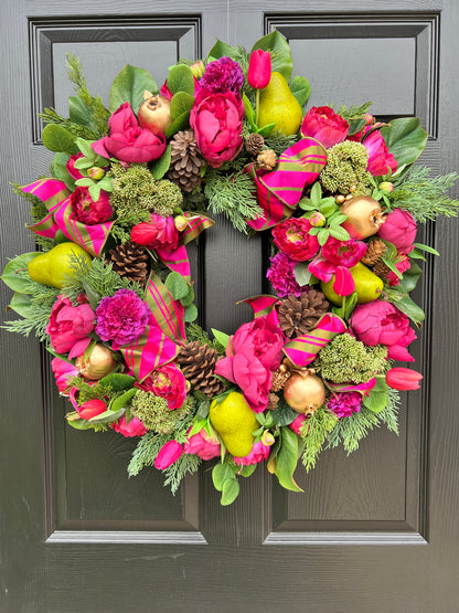 Lush fuchsia and green floral and fruit winter wreath