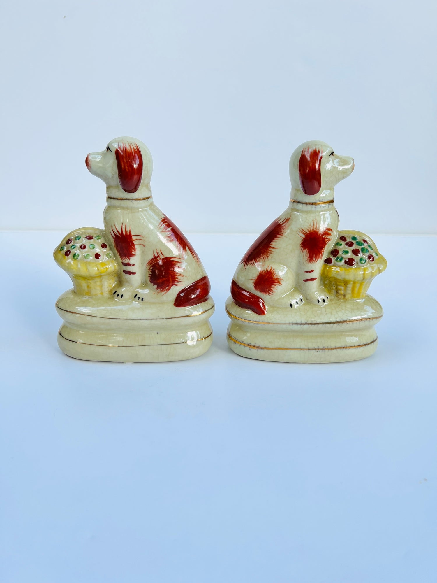 Staffordshire dog pair with flower baskets rust