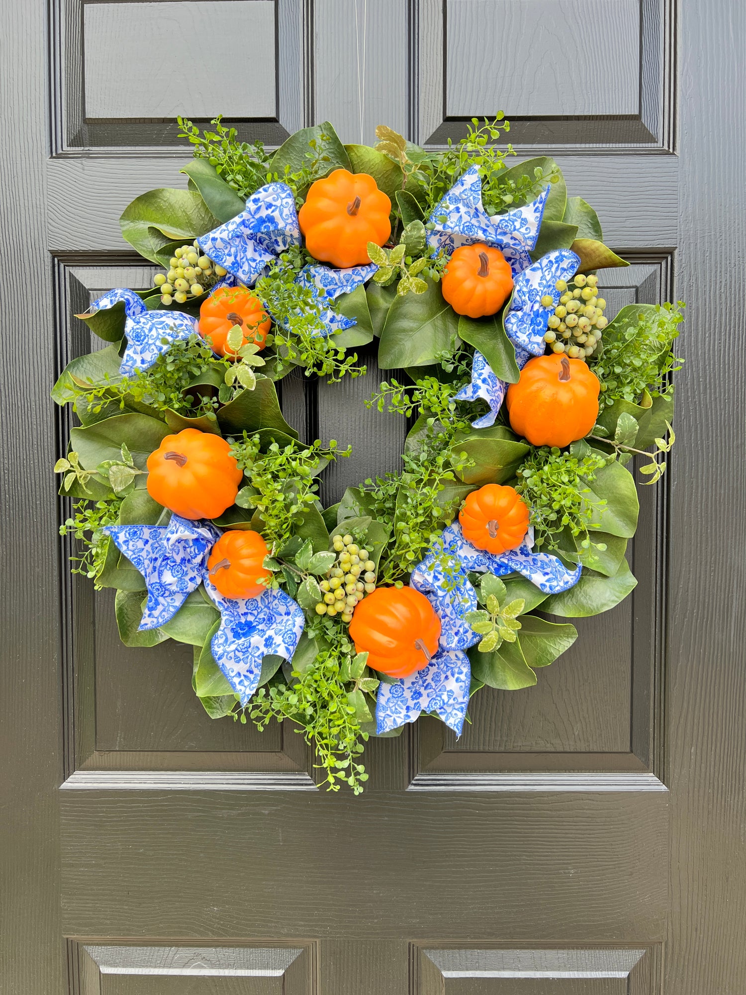 Orange pumpkin wreath with blue and white chinoiserie ribbon