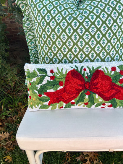 Red bow and greenery hand hooked lumbar pillow