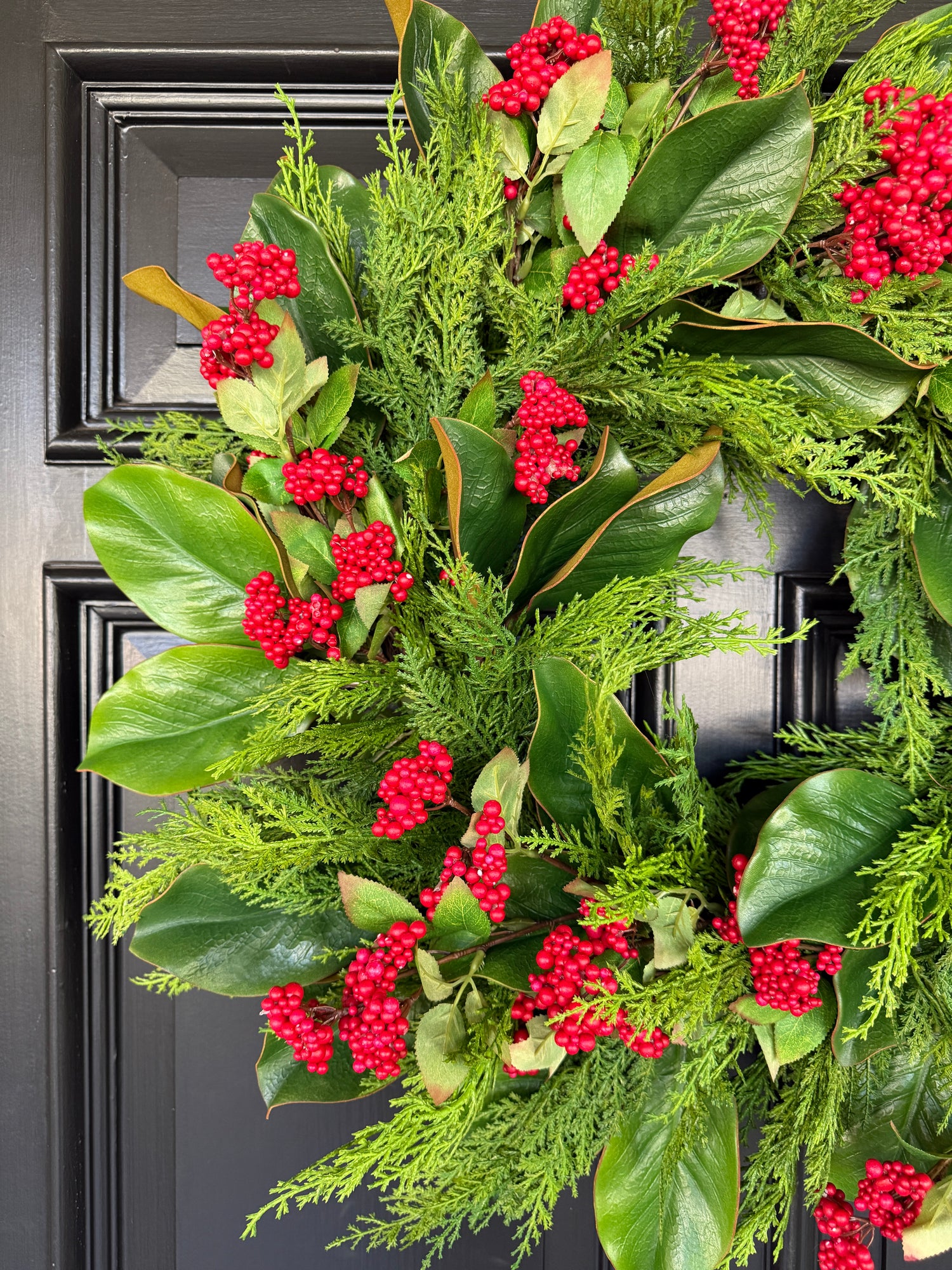 Red berry, cedar, and magnolia leaf wreath 27”