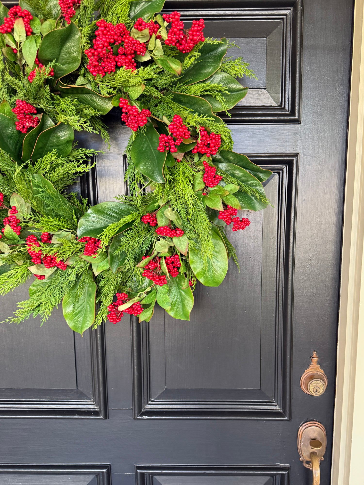 Red berry, cedar, and magnolia leaf wreath 27”