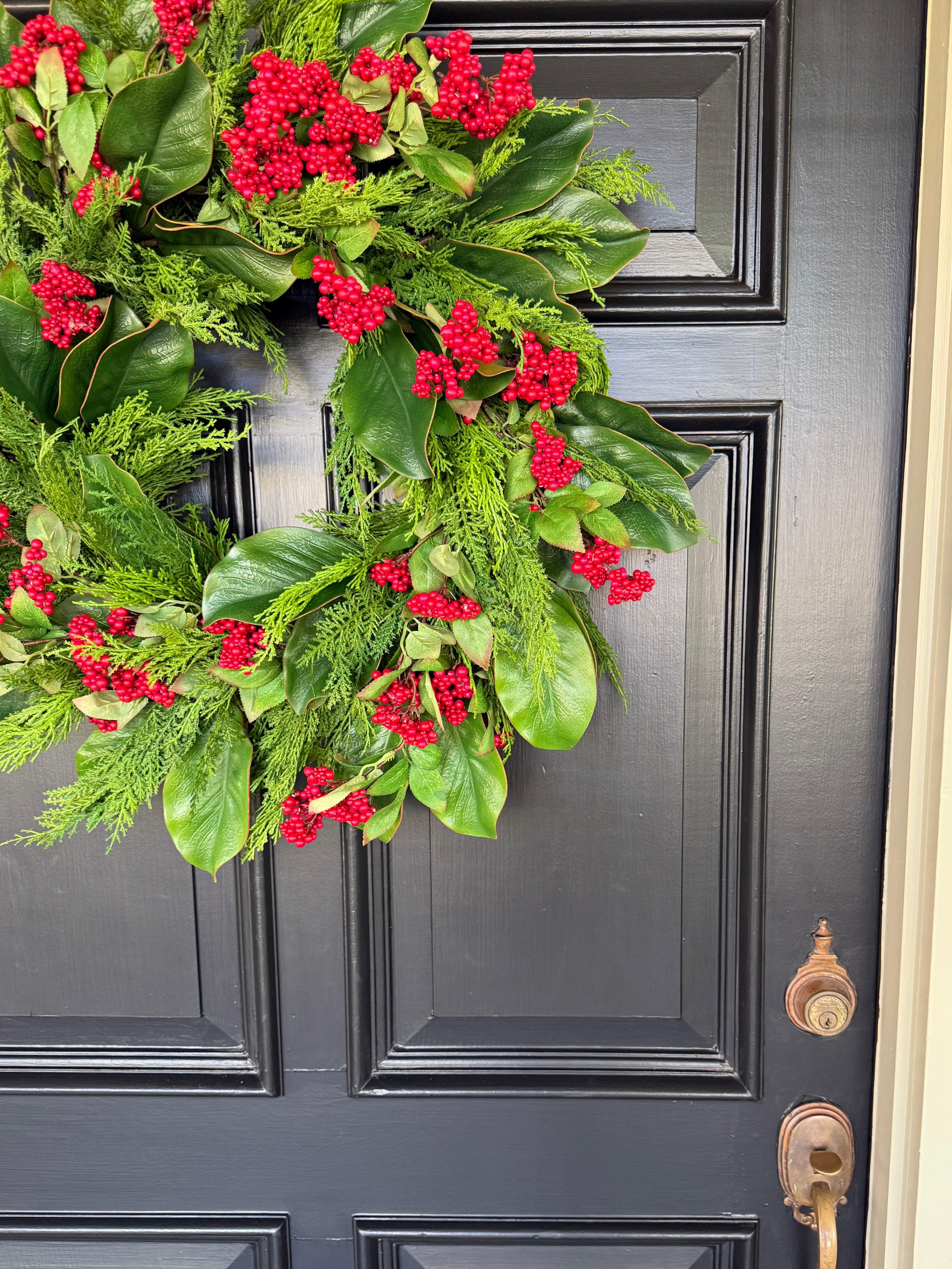 Red berry, cedar, and magnolia leaf wreath 27”