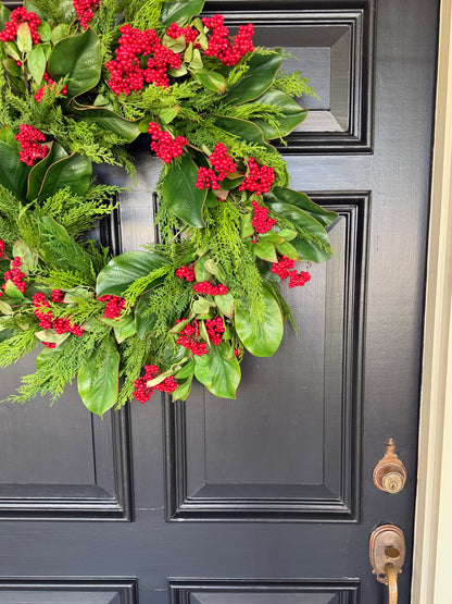 Red berry, cedar, and magnolia leaf wreath 27”