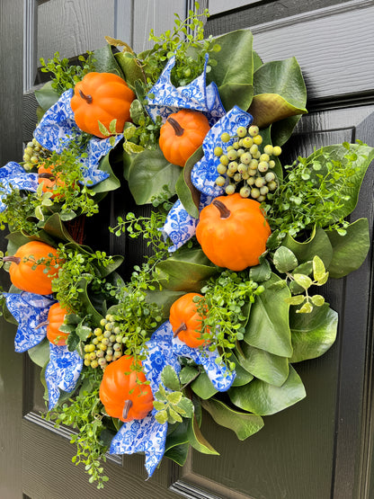 Orange pumpkin wreath with blue and white chinoiserie ribbon